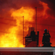 In this May, 1985 file photo, a Philadelphia policeman is seen on a rooftop as flames rise from a row of burning homes beyond, in Philadelphia. The fire started when police dropped a bomb onto the house of the militant group MOVE, on May 13, 1985 and fire spread throughout the area.